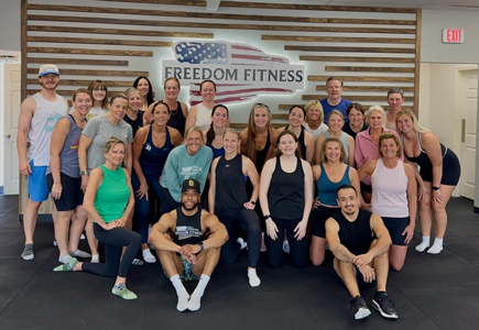 Group photo of members and trainers gathered together after a community fitness class at Freedom Fitness O’Fallon.