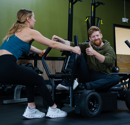 Personal trainer encouraging a client during a cardio and strength workout session at Freedom Fitness O’Fallon.